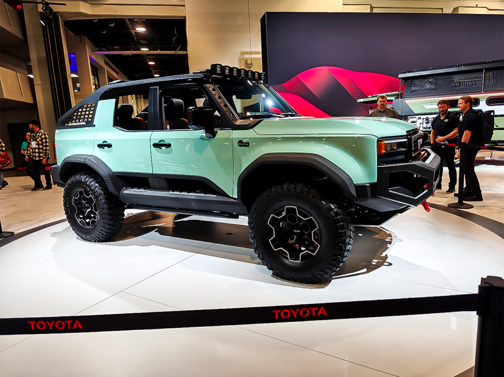 SEMA 2024 showcase featuring STILLEN's top picks: custom Nissan Z, Nissan Frontier Tarmac Edition, Infiniti QX80, Toyota Tacoma builds with Icon Vehicle Dynamics suspension, TruControl tuner, and TruPower intake, and Toyota's concept off-roaders including TRD Surf and Land Cruiser Rox