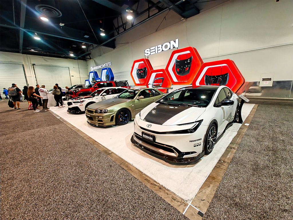 SEMA 2024 showcase featuring STILLEN's top picks: custom Nissan Z, Nissan Frontier Tarmac Edition, Infiniti QX80, Toyota Tacoma builds with Icon Vehicle Dynamics suspension, TruControl tuner, and TruPower intake, and Toyota's concept off-roaders including TRD Surf and Land Cruiser Rox