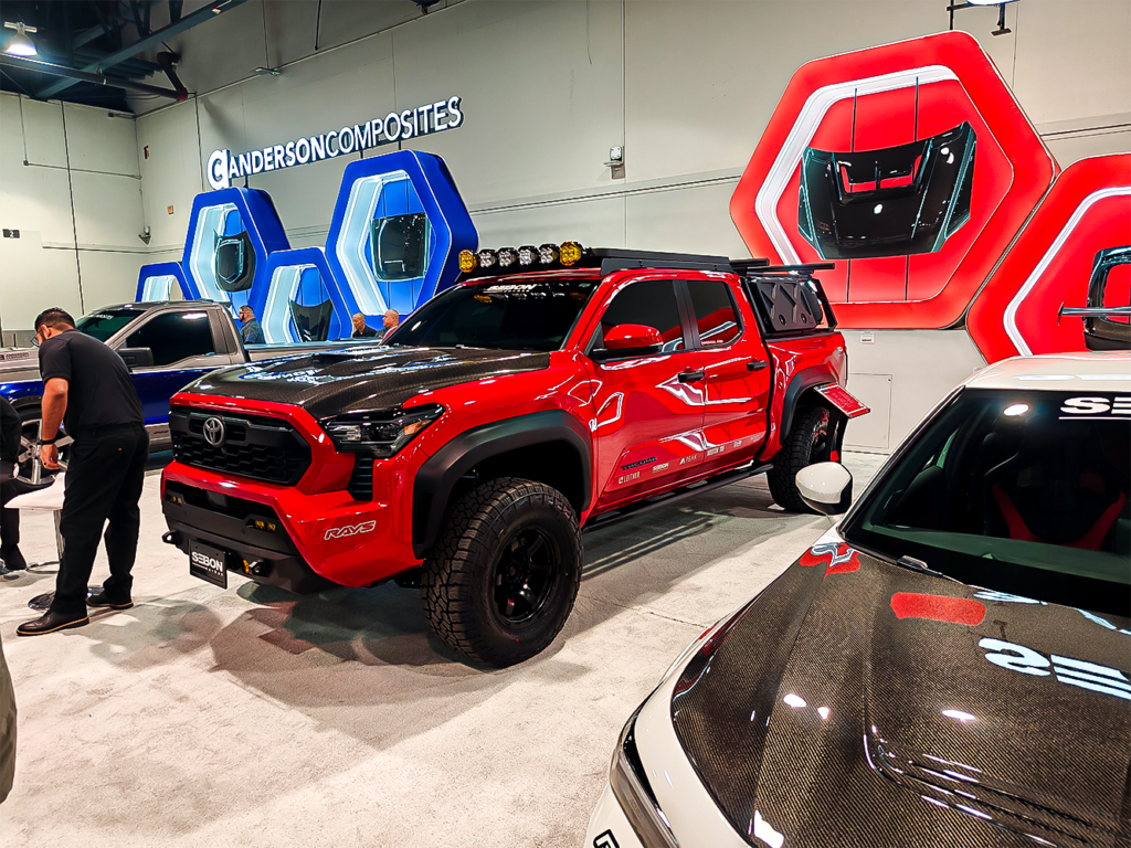 SEMA 2024 showcase featuring STILLEN's top picks: custom Nissan Z, Nissan Frontier Tarmac Edition, Infiniti QX80, Toyota Tacoma builds with Icon Vehicle Dynamics suspension, TruControl tuner, and TruPower intake, and Toyota's concept off-roaders including TRD Surf and Land Cruiser Rox