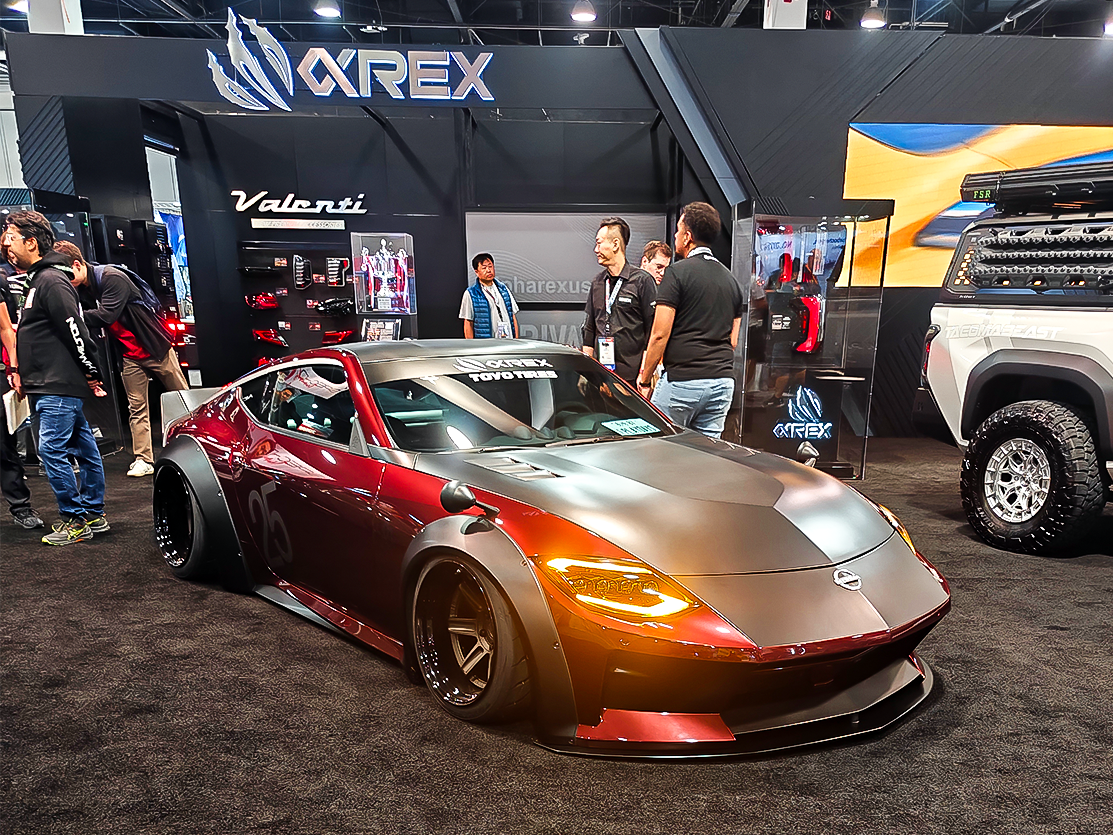 SEMA 2024 showcase featuring STILLEN's top picks: custom Nissan Z, Nissan Frontier Tarmac Edition, Infiniti QX80, Toyota Tacoma builds with Icon Vehicle Dynamics suspension, TruControl tuner, and TruPower intake, and Toyota's concept off-roaders including TRD Surf and Land Cruiser Rox